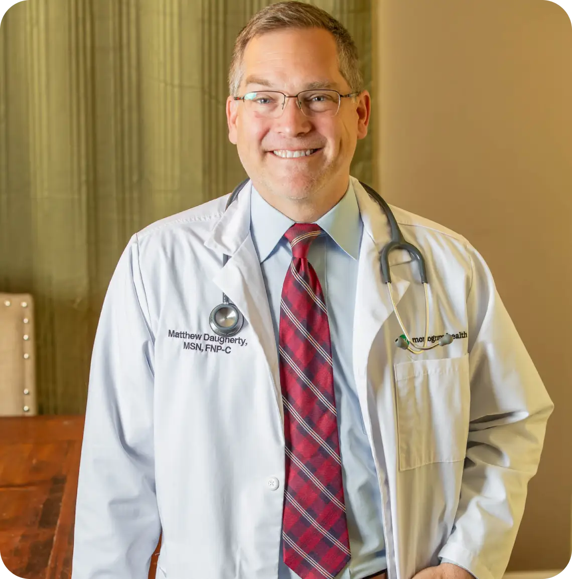 Smiling male doctor with stethoscope
