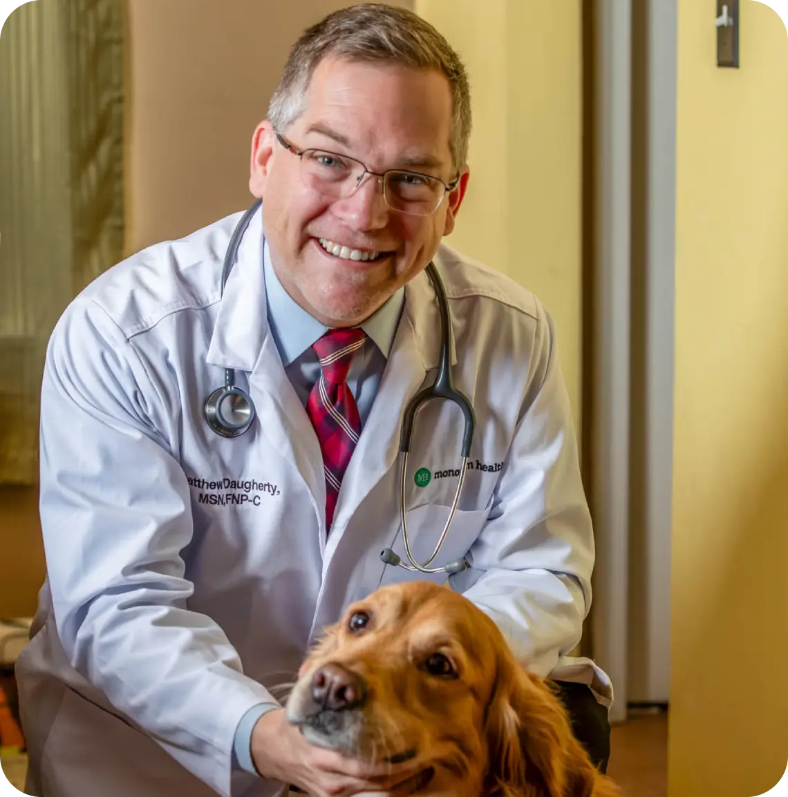 Smiling veterinarian with golden retriever dog